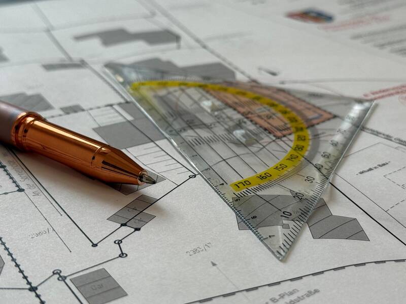 Bauplan mit Geodreieck und Stift 