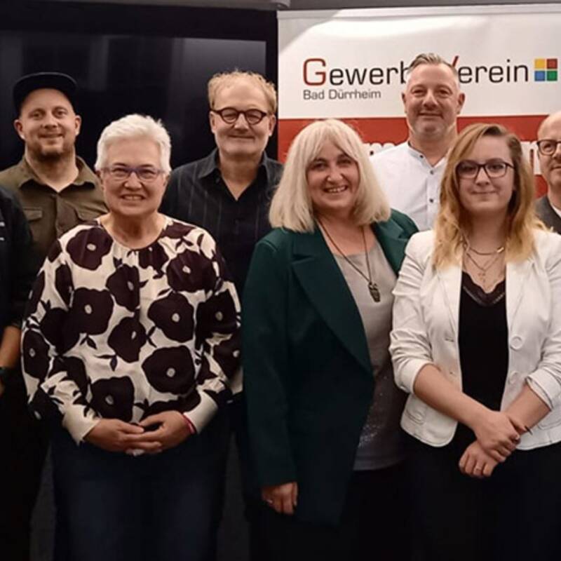 Gruppe von neun Personen vor einem Banner mit der Aufschrift 'Gewerbeverein Bad Dürrheim'.